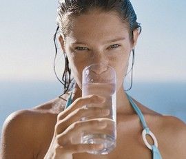 Drinking water to prevent constipation.