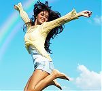 Young Beautiful Woman Jumping To The Sky.
